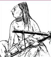 A Chinook Indian from the American West Coast with a baby in a wooden squeeze.
